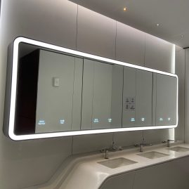 public washroom lighted mirror with integrated soap dispenser and towel dispenser